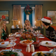 The cast of Chucky sits around a table for Christmas dinner